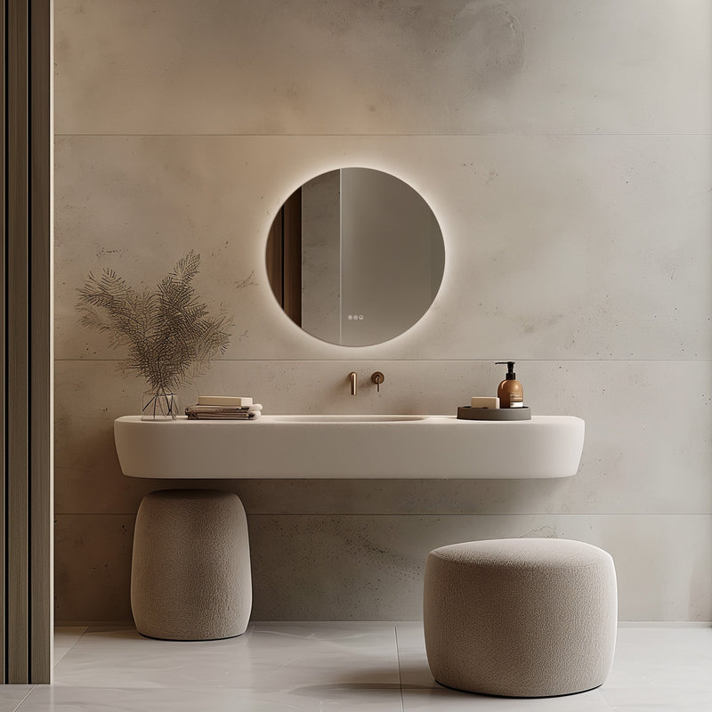 Claris Round 80cm LED bathroom mirror with touch sensor and backlit frame, styled in a warm neutral bathroom with brushed brass tap and modern basin - Origins Living mirror at BathLab
